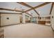 Living room with wood beam ceilings, stone fireplace, and built-in wet bar at 161 Cindy Ct, Lake Mary, FL 32746