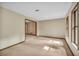 Spacious living room featuring neutral carpet, natural light from two large windows, and doorway to other rooms at 161 Cindy Ct, Lake Mary, FL 32746