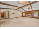 Living room with wood beam ceilings, stone fireplace, and two windows at 161 Cindy Ct, Lake Mary, FL 32746