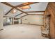 Living room with wood beam ceilings, stone fireplace, and view to backyard at 161 Cindy Ct, Lake Mary, FL 32746