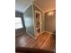 Bright bathroom with vinyl floors and a view of the toilet and shower through the doorway at 1626 Cypress Pt, Lady Lake, FL 32159