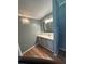 Bathroom featuring vinyl floors, vanity with drawers, countertop, a mirror, and light fixture at 1626 Cypress Pt, Lady Lake, FL 32159