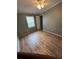 Bedroom featuring vinyl floors, window with blinds, a ceiling fan, and a door to another room at 1626 Cypress Pt, Lady Lake, FL 32159