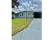 Charming single-story home with a well-maintained lawn and a convenient carport at 1626 Cypress Pt, Lady Lake, FL 32159