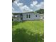 Exterior of a single story house with a large lawn and a screened-in porch at 1626 Cypress Pt, Lady Lake, FL 32159
