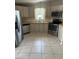 Modern kitchen with stainless steel appliances, light countertops, and ample cabinet space at 1626 Cypress Pt, Lady Lake, FL 32159