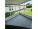 Covered patio overlooking the green backyard, enclosed by white metal frames and lush greenery at 1626 Cypress Pt, Lady Lake, FL 32159