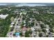 Aerial view of a home surrounded by trees near a lake at 1730 Dorset Dr, Mount Dora, FL 32757
