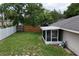 Large backyard with a white and wood fence and screened in room at 1730 Dorset Dr, Mount Dora, FL 32757
