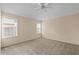 Serene bedroom with carpet, neutral-colored walls, large windows, and a ceiling fan for optimal comfort at 1730 Dorset Dr, Mount Dora, FL 32757