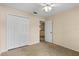 Bedroom with a ceiling fan, closet and door to hallway, providing ample storage at 1730 Dorset Dr, Mount Dora, FL 32757