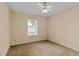 Bedroom with neutral carpeting, a ceiling fan, and a window providing natural light at 1730 Dorset Dr, Mount Dora, FL 32757