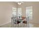 Charming dining area featuring neutral walls, tile flooring, large windows, and a comfortable four-chair dining set at 1730 Dorset Dr, Mount Dora, FL 32757
