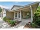 Charming home with a covered front porch, neutral siding and well-maintained landscaping at 1730 Dorset Dr, Mount Dora, FL 32757