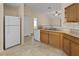 Functional kitchen offering ample cabinet space, granite countertops, white appliances, and tiled flooring at 1730 Dorset Dr, Mount Dora, FL 32757