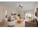 Bright living room features neutral decor, cozy seating, and a sliding glass door to the backyard at 1730 Dorset Dr, Mount Dora, FL 32757