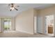 Comfortable main bedroom featuring carpet, a ceiling fan, patio access, and an en-suite bathroom at 1730 Dorset Dr, Mount Dora, FL 32757