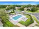 Aerial view of community pool, playground, and common spaces creating a vibrant and enjoyable recreational area for residents at 17428 Woodfair Dr, Clermont, FL 34711