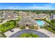 Aerial view of a community clubhouse and pool area surrounded by well-maintained landscaping in a residential neighborhood at 17428 Woodfair Dr, Clermont, FL 34711