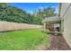 Fenced backyard showcasing green grass and privacy features, creating a private and enjoyable outdoor space at 17428 Woodfair Dr, Clermont, FL 34711