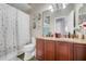 Bathroom with double sink vanity and a shower tub combination with nice countertops and wall decor at 17428 Woodfair Dr, Clermont, FL 34711