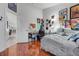 A spacious bedroom with light colored walls, wood floors, and a doorway to the hallway at 17428 Woodfair Dr, Clermont, FL 34711