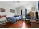 Cozy bedroom with wooden floors, neutral walls, and a built in desk area for studying or hobbies at 17428 Woodfair Dr, Clermont, FL 34711