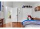 Bedroom with an adjoining bathroom, closet and built in storage, and light wood floors at 17428 Woodfair Dr, Clermont, FL 34711