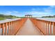 Stunning wooden dock and gazebo lead onto the lake with beautiful views and a tranquil atmosphere at 17428 Woodfair Dr, Clermont, FL 34711