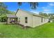 The home's exterior, complemented by a well-maintained lawn and mature trees, offers a serene and inviting atmosphere at 17428 Woodfair Dr, Clermont, FL 34711