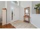 Bright foyer with tile flooring, coat rack, and natural light streaming through the door windows at 17428 Woodfair Dr, Clermont, FL 34711
