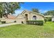 Well-kept single-story home featuring lush green lawn and established landscaping around the perimeter at 17428 Woodfair Dr, Clermont, FL 34711
