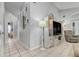 Hallway with white floor lamp, console and tile flooring at 17428 Woodfair Dr, Clermont, FL 34711