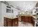Kitchen with island, granite countertops, and stainless steel appliances at 17428 Woodfair Dr, Clermont, FL 34711