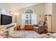 Bright living room with an arched window and comfortable seating at 17428 Woodfair Dr, Clermont, FL 34711