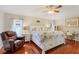 The main bedroom offers a light and airy feel with hardwood floors at 17428 Woodfair Dr, Clermont, FL 34711