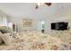 Bedroom featuring hardwood floors, a ceiling fan, and ample natural light at 17428 Woodfair Dr, Clermont, FL 34711
