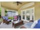 Covered patio area perfect for outdoor entertaining and relaxation on comfortable rattan furniture at 17428 Woodfair Dr, Clermont, FL 34711