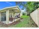 Covered patio area with comfortable seating and a ceiling fan, perfect for enjoying the outdoors in comfort at 17428 Woodfair Dr, Clermont, FL 34711