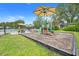 Community playground with shade, play structures, and picnic tables next to community pool at 17428 Woodfair Dr, Clermont, FL 34711
