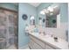 Well-lit blue bathroom with a seashell-themed shower curtain at 17533 Se 96Th Ct, Summerfield, FL 34491