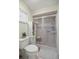 Bathroom featuring a toilet, glass shower, and storage shelf at 17533 Se 96Th Ct, Summerfield, FL 34491