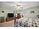 Comfortable bedroom with ceiling fan, carpet and lots of decorative items at 17533 Se 96Th Ct, Summerfield, FL 34491