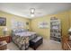Comfortable bedroom with a ceiling fan, two windows, and ample closet space at 17533 Se 96Th Ct, Summerfield, FL 34491