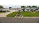 Charming single-story home featuring well-manicured lawn and flowerbeds, plus an attached two-car garage at 17533 Se 96Th Ct, Summerfield, FL 34491