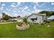 Landscaped front yard with vibrant flowerbeds, healthy green lawn, and a charming flower planter at 17533 Se 96Th Ct, Summerfield, FL 34491