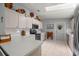 Well-lit kitchen with ample counter space, stainless steel appliances, and white cabinets at 17533 Se 96Th Ct, Summerfield, FL 34491