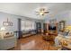 Inviting living room with hardwood floors, lots of furniture, and a large window at 17533 Se 96Th Ct, Summerfield, FL 34491