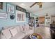 Comfortable living room with light blue walls, tile floors, and a large sofa at 17533 Se 96Th Ct, Summerfield, FL 34491