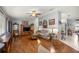 Cozy living room featuring wood floors, neutral walls, and comfortable seating arrangement with decorative accents at 17533 Se 96Th Ct, Summerfield, FL 34491